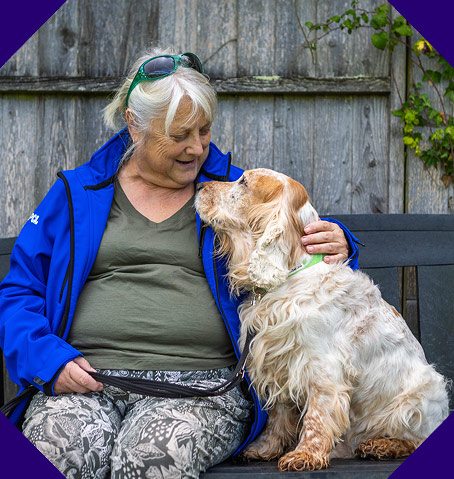 Older woman and her senior dog look at each other lovingly