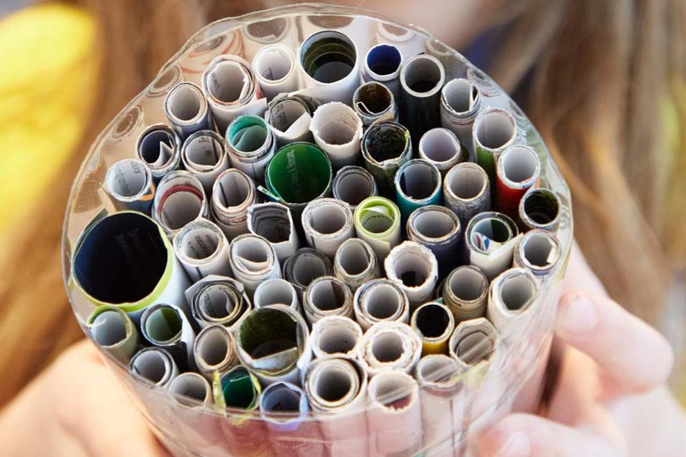 A bug hotel made of a circle of various sized cylindrical objects.